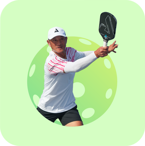 Man, wearing all white on top and black shorts, hitting a forehand while playing pickleball with Universal Tennis