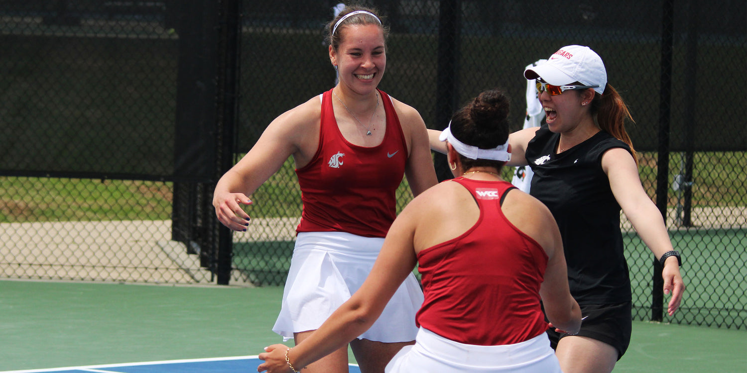 Three women for Washington State University playing tennis on a court with a fence in the background while winning the UTR Sports NIT Championship that supports college tennis